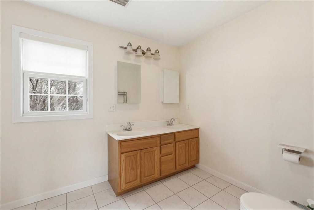 238 Sterling Street Fall River, MA 02721 - Photo 11 of 17 a bathroom with a sink a toilet and mirror