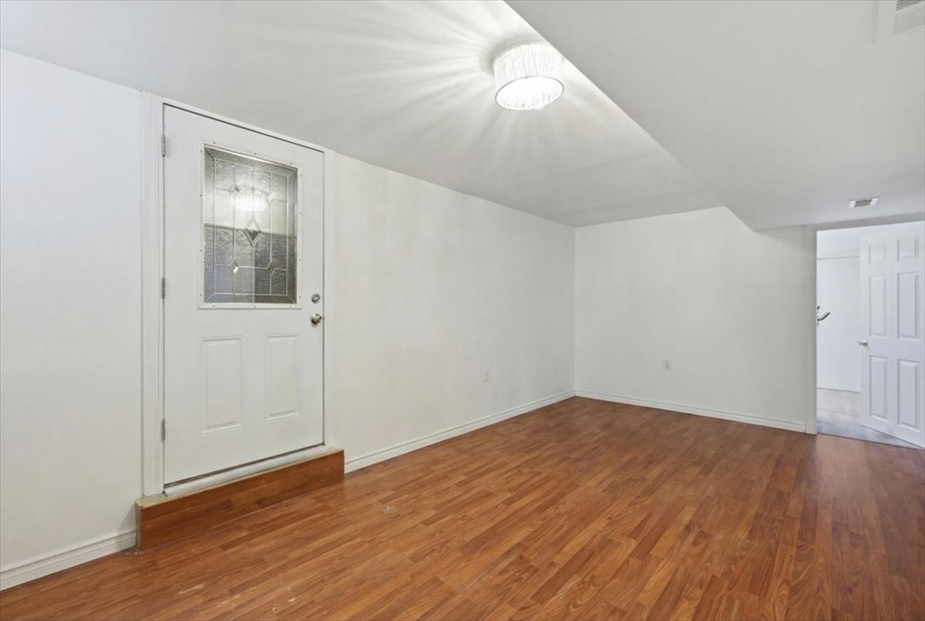 238 Sterling Street Fall River, MA 02721 - Photo 14 of 17 an empty room with wooden floor and windows
