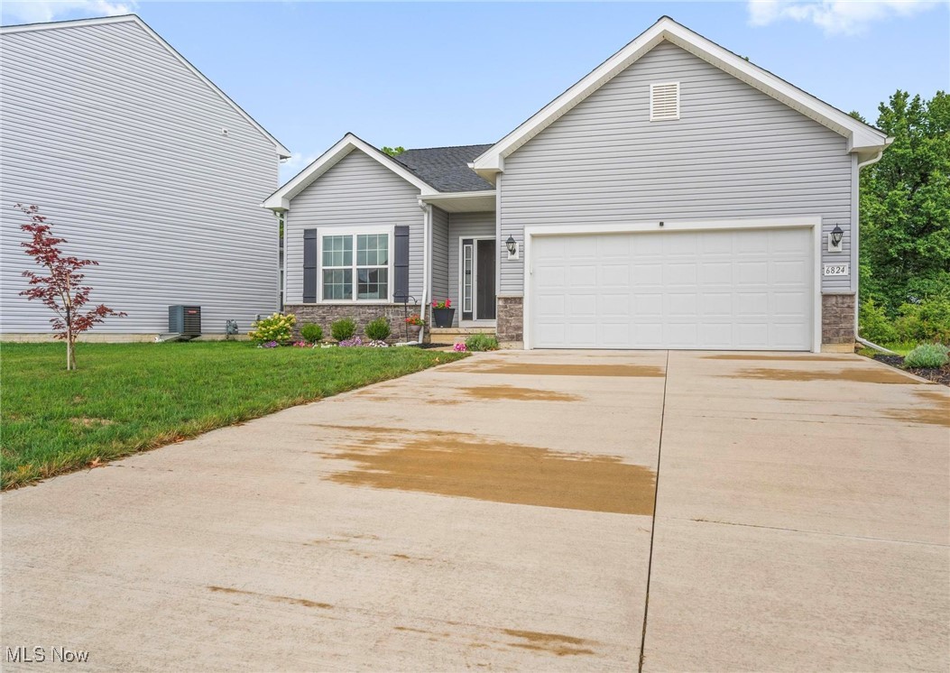 6824 Hatching Way North Ridgeville, OH 44039 - Photo 1 of 42 View of front of house featuring a garage, central air condition unit, and a front lawn
