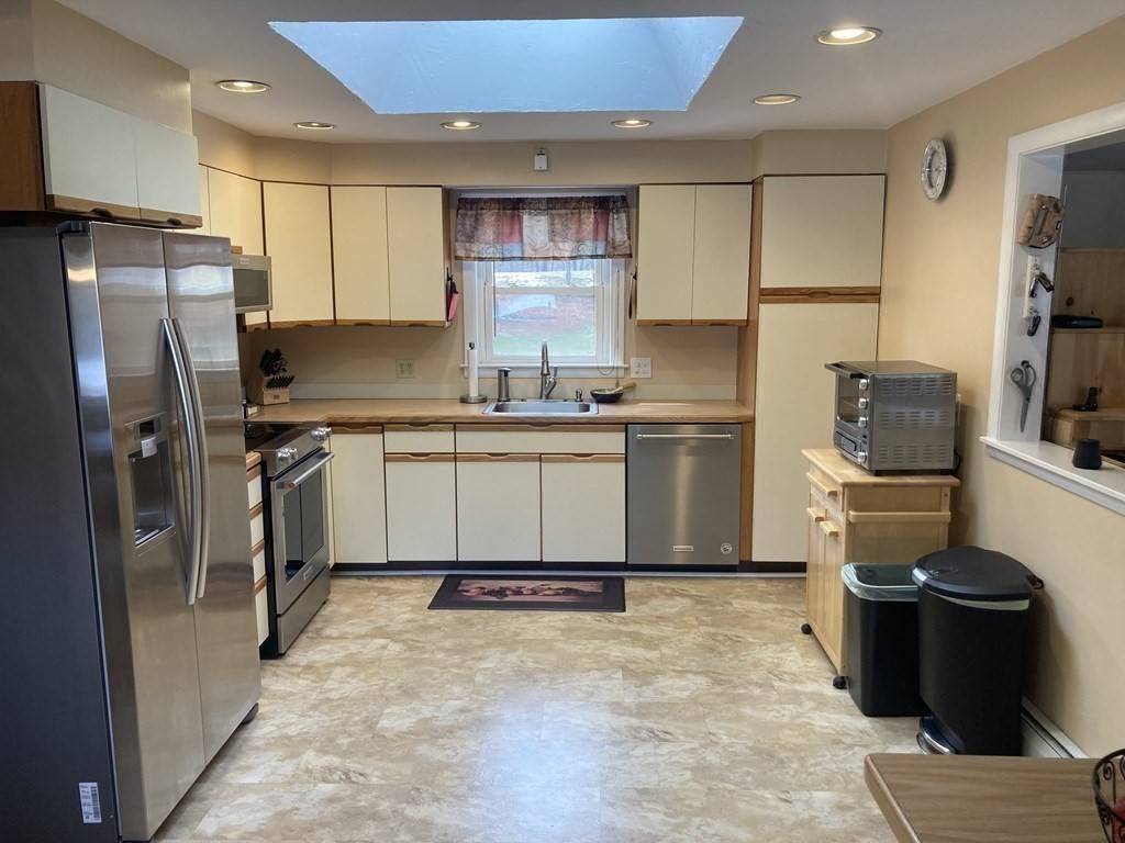 17 Adams Road Grafton, MA 01519 - Photo 14 of 42 a kitchen with stainless steel appliances granite countertop a refrigerator stove top oven and sink