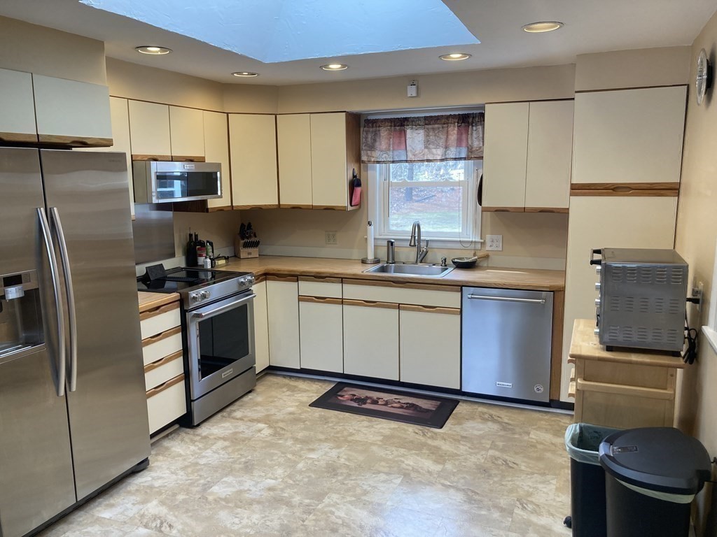 17 Adams Road Grafton, MA 01519 - Photo 15 of 42 a kitchen with a sink stove and refrigerator