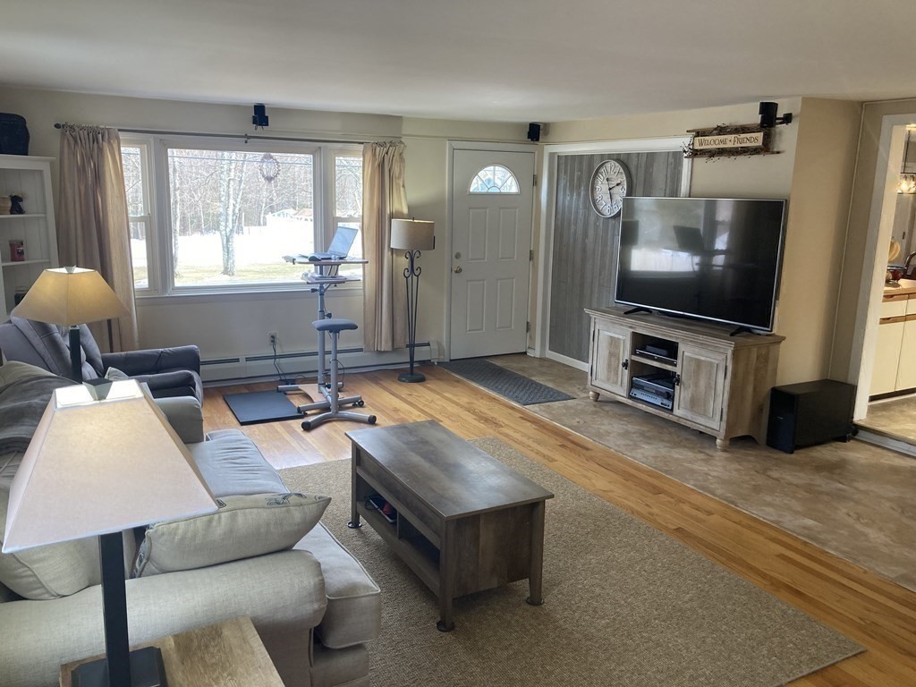 17 Adams Road Grafton, MA 01519 - Photo 18 of 42 a living room with furniture and a flat screen tv