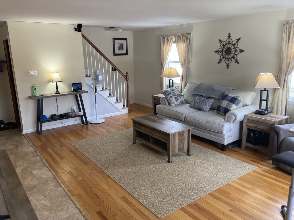 17 Adams Road Grafton, MA 01519 - Photo 19 of 42 a living room with furniture and a lamp