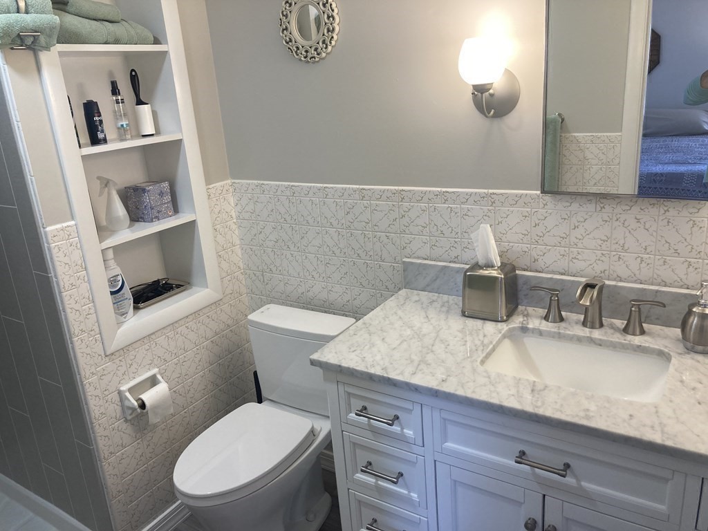 17 Adams Road Grafton, MA 01519 - Photo 24 of 42 a bathroom with a granite countertop toilet sink and mirror