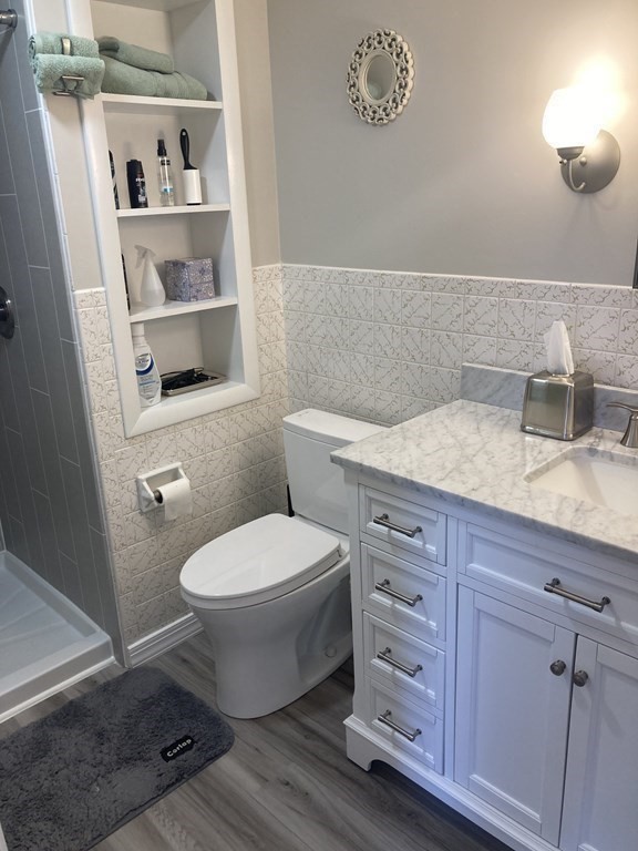 17 Adams Road Grafton, MA 01519 - Photo 25 of 42 a bathroom with a toilet a sink and vanity