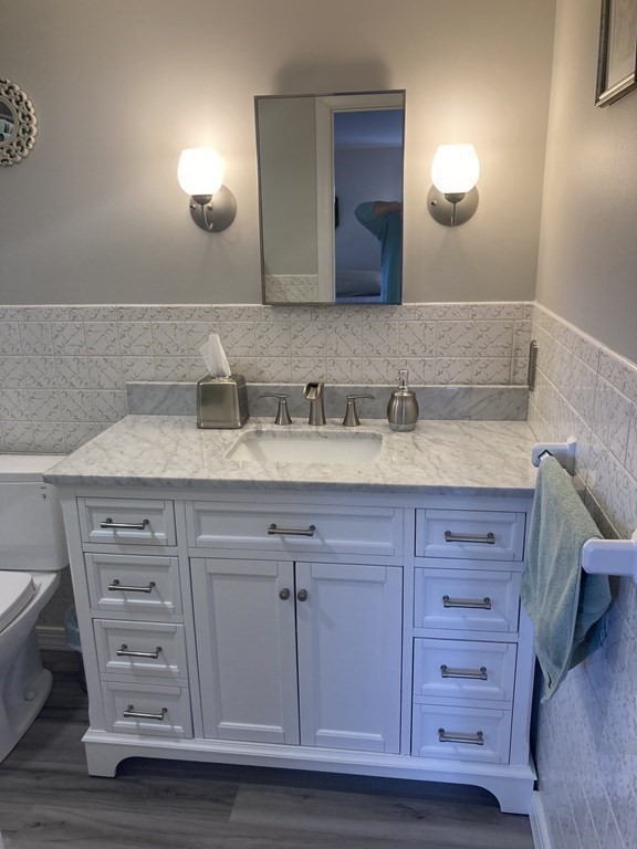 17 Adams Road Grafton, MA 01519 - Photo 26 of 42 a bathroom with a sink vanity and a mirror