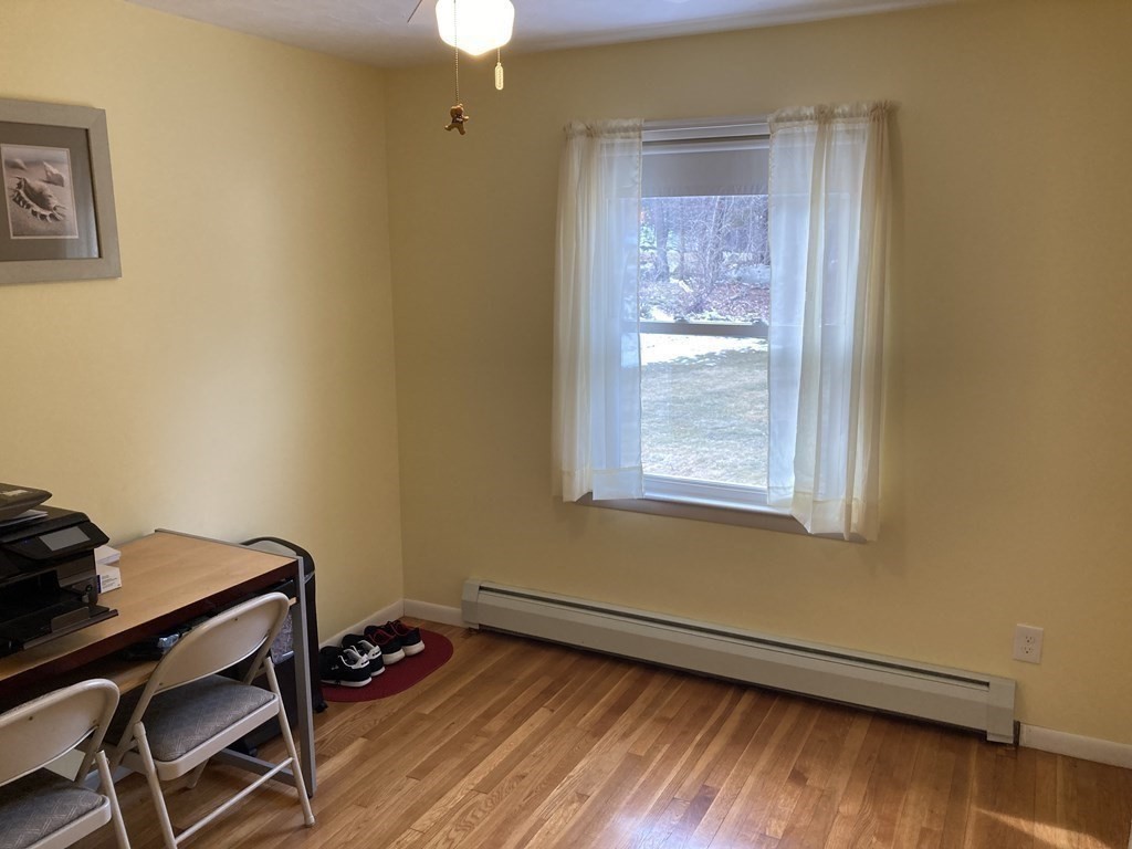 17 Adams Road Grafton, MA 01519 - Photo 31 of 42 a bedroom with a bed and wooden floor