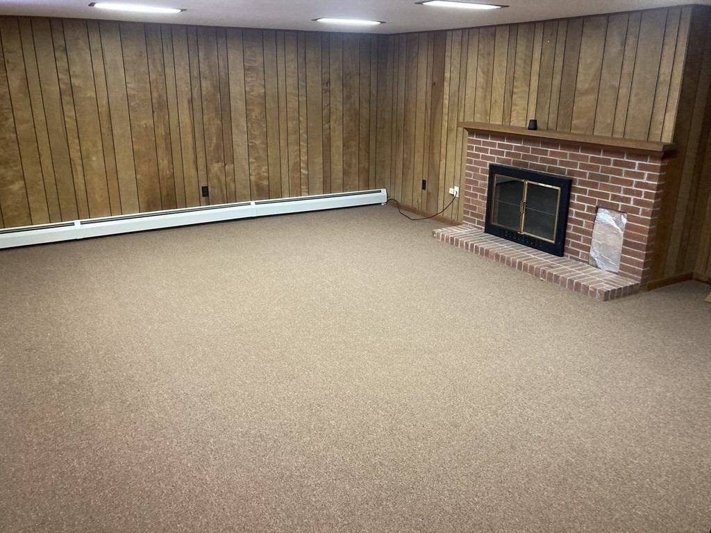17 Adams Road Grafton, MA 01519 - Photo 34 of 42 an empty room with a fireplace