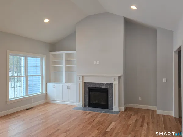 a view of a livingroom with a fireplace and window
