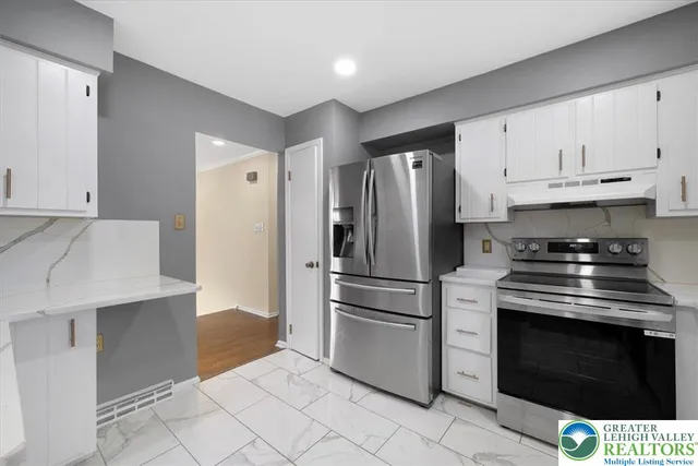 a kitchen with cabinets and stainless steel appliances