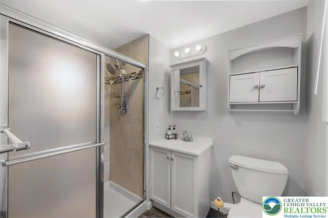 a bathroom with a toilet sink and shower