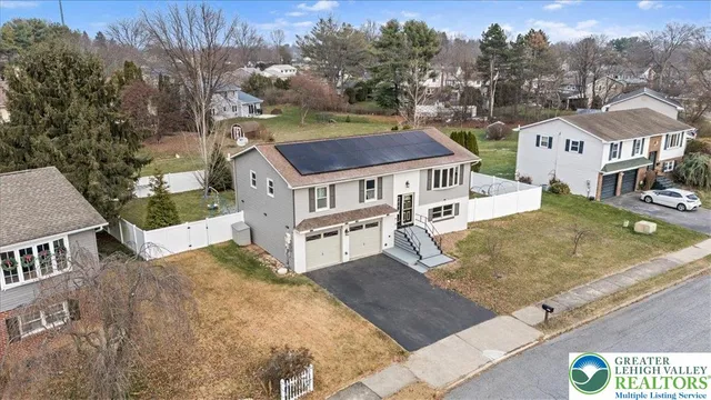 an aerial view of residential houses with yard
