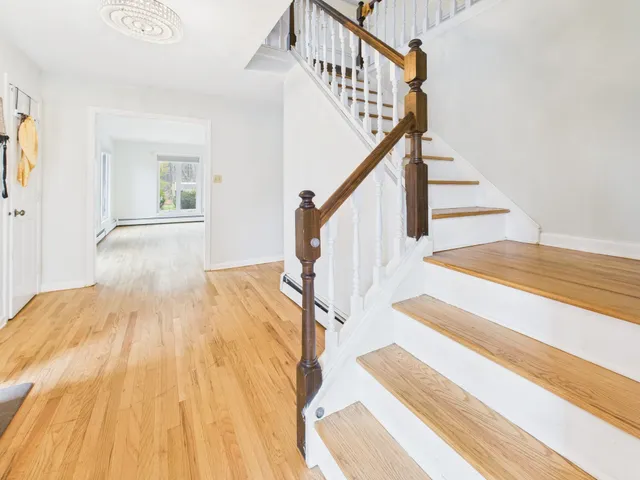 a view of entryway and hall with wooden floor