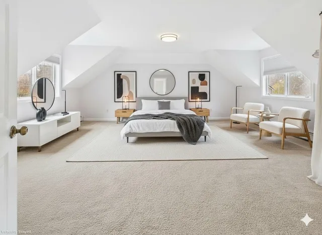 a bedroom with furniture and a mirror