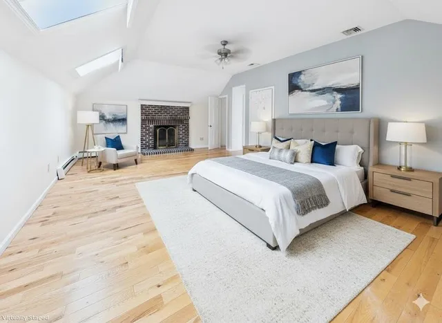 a large bedroom with a bed and a fireplace