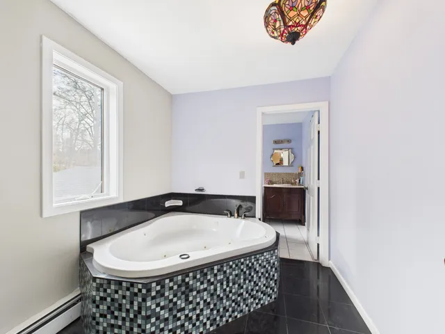 a bathroom with a sink a mirror and a window