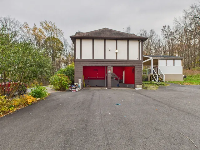 a view of a house with a yard and garage