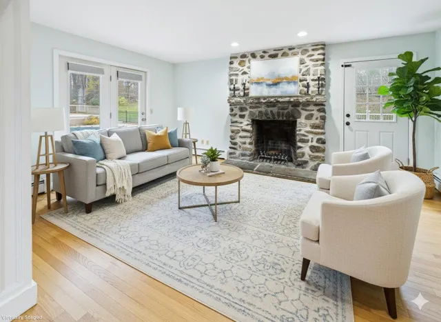 a living room with furniture and a fireplace