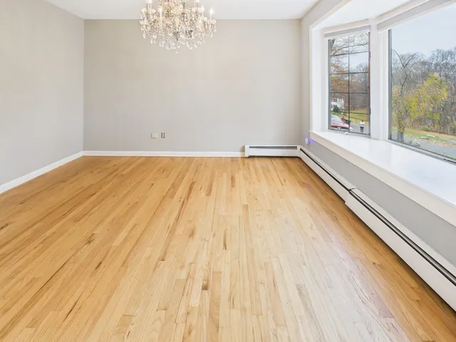 a view of a room with wooden floor and windows