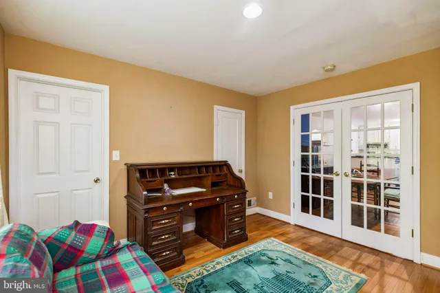 a view of a bedroom with furniture and window