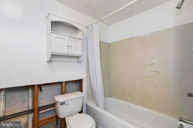 a bathroom with a toilet a sink and bathtub