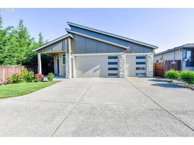 a view of a house with a yard and garage