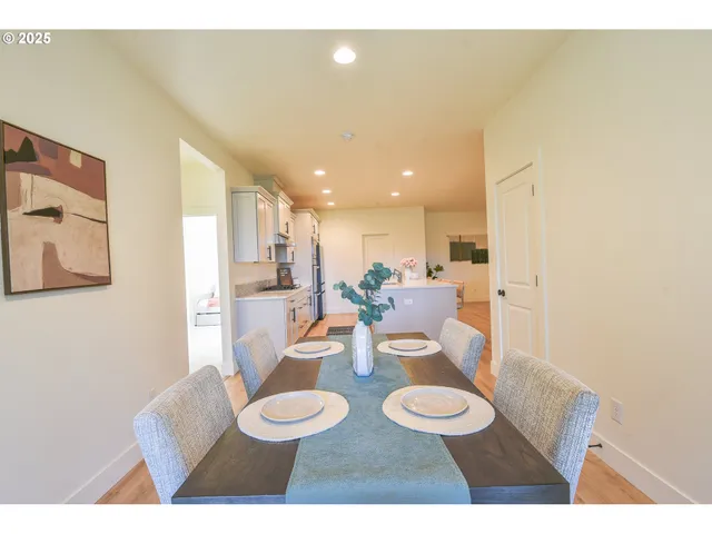 a dining room with furniture and a wooden floor