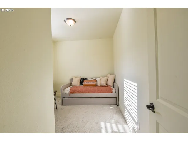 a bedroom with a bed and a night stand