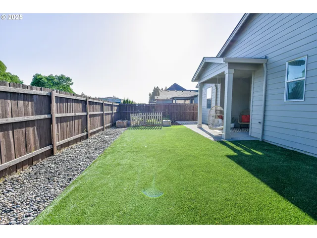 a view of a house with a yard and deck