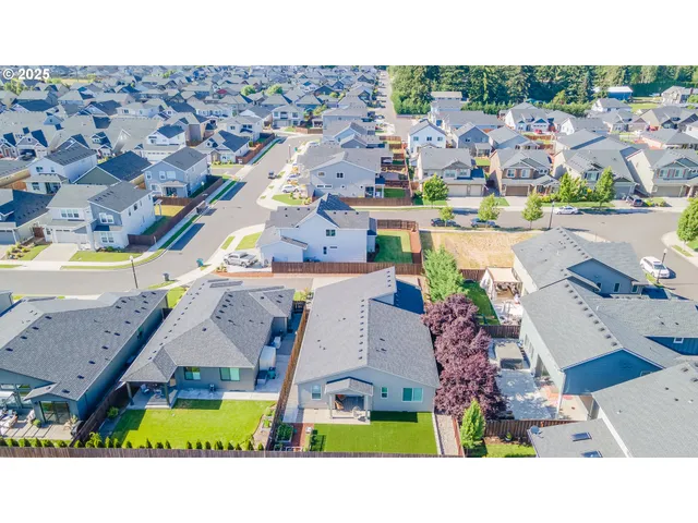 an aerial view of a house with a swimming pool yard and outdoor seating
