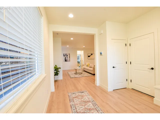 a view of a bedroom with wooden floor and furniture