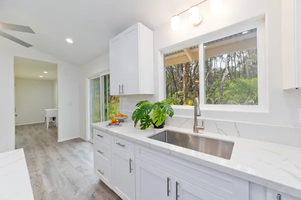 a kitchen with a large window and sink