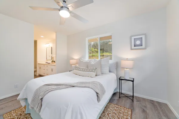 a bedroom with a bed and a chandelier