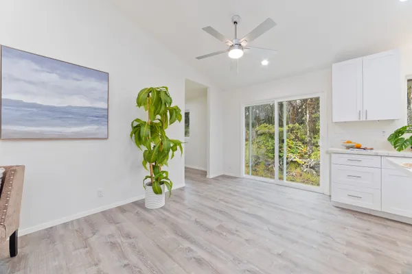 a view of a room with window wooden floor and front door