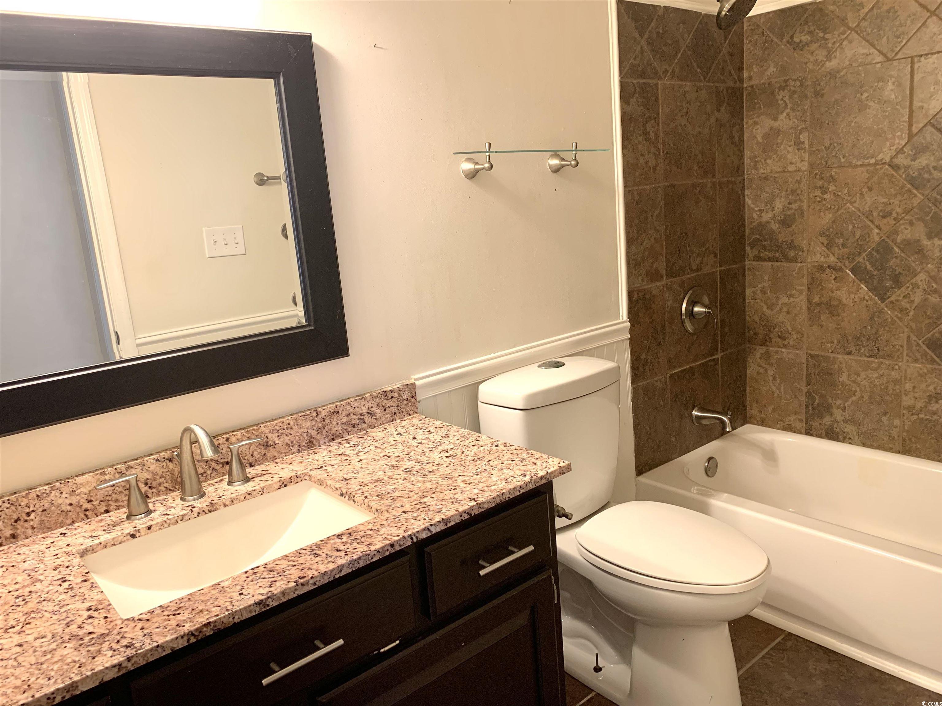 105 Willow Ridge Road Myrtle Beach, SC 29588 - Photo 16 of 23 Bathroom with vanity, a textured ceiling, and wood finished floors