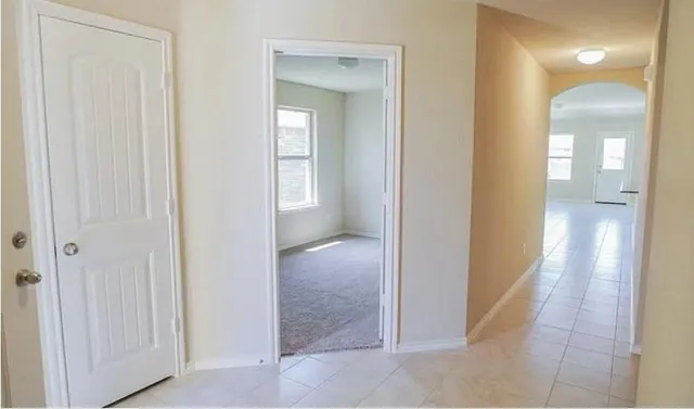 a view of a hallway with a wooden cabinets