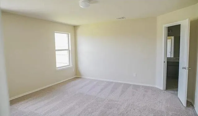 an empty room with windows and closet