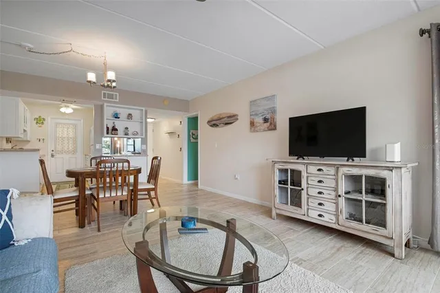 a view of a livingroom with furniture and a flat screen tv
