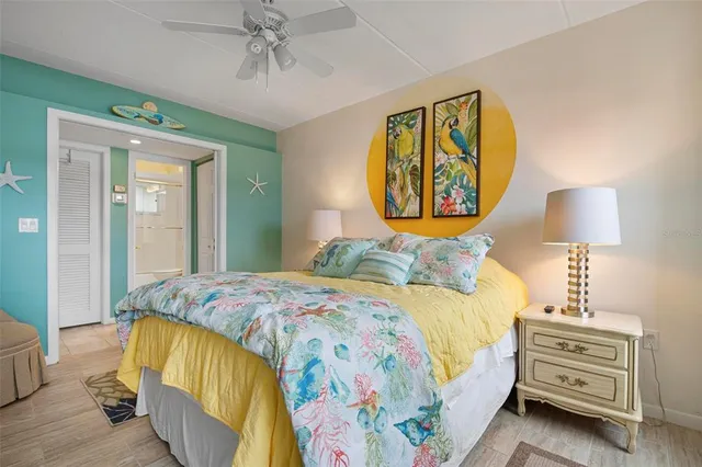 a bedroom with a bed and a lamp on dresser