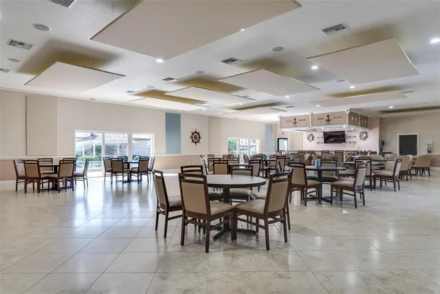 a view of a dining room with furniture and chandelier