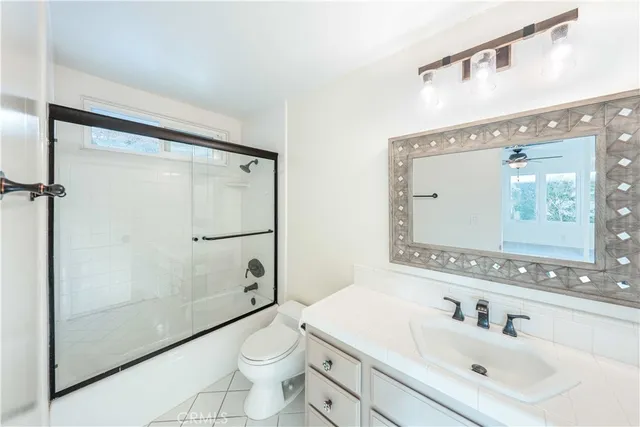 a view of a kitchen with wooden floor and a window