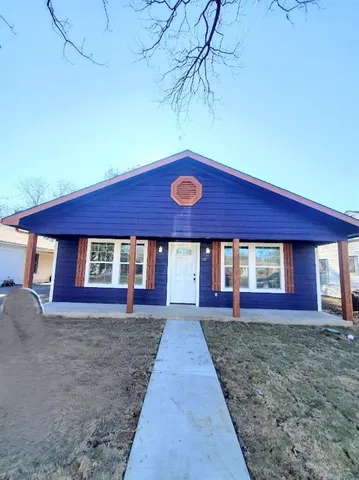 a view of a house with a yard and garage