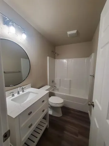 a bathroom with a double vanity sink toilet and a mirror