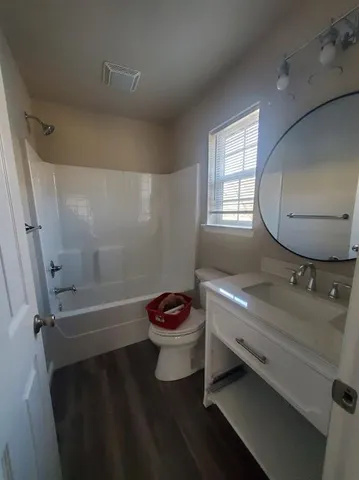 a bathroom with a sink a toilet and a bathtub