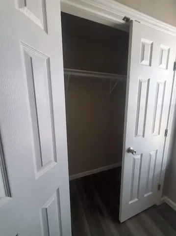a view of walk in closet with empty racks