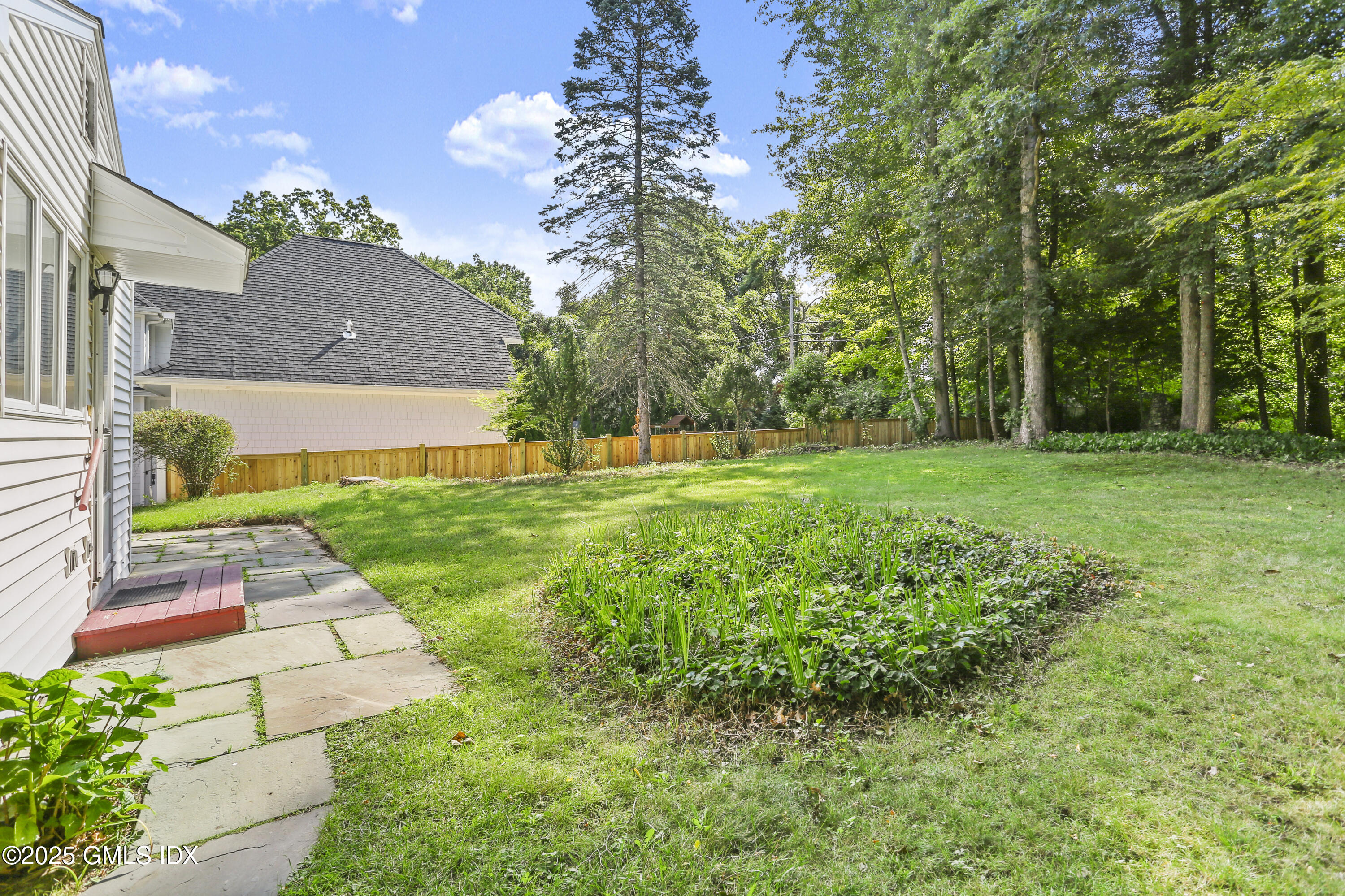 25 Circle Drive Greenwich, CT 06830 - Photo 2 of 7 a view of a yard with plants and large trees