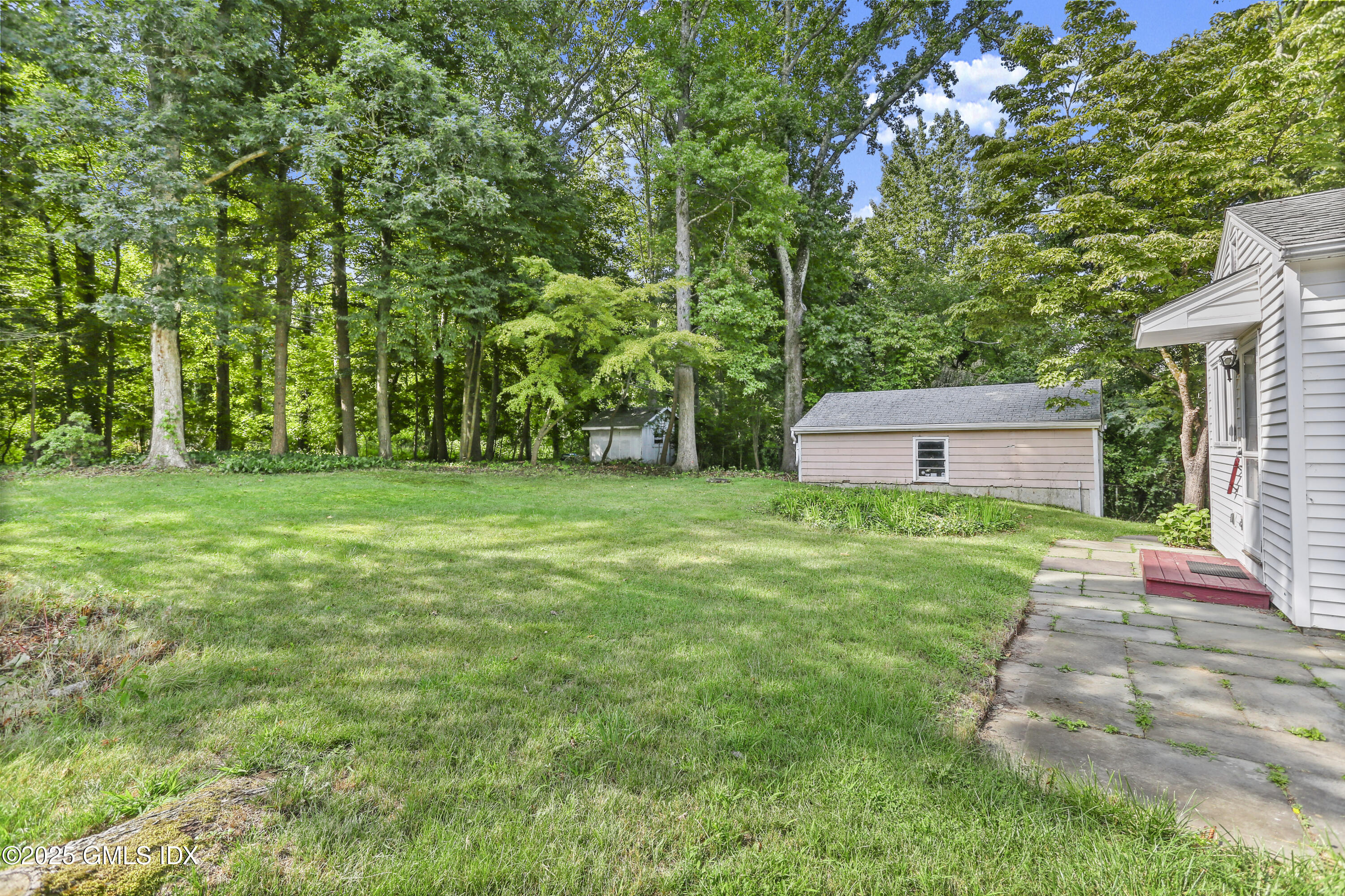 25 Circle Drive Greenwich, CT 06830 - Photo 5 of 7 a front view of a house with garden