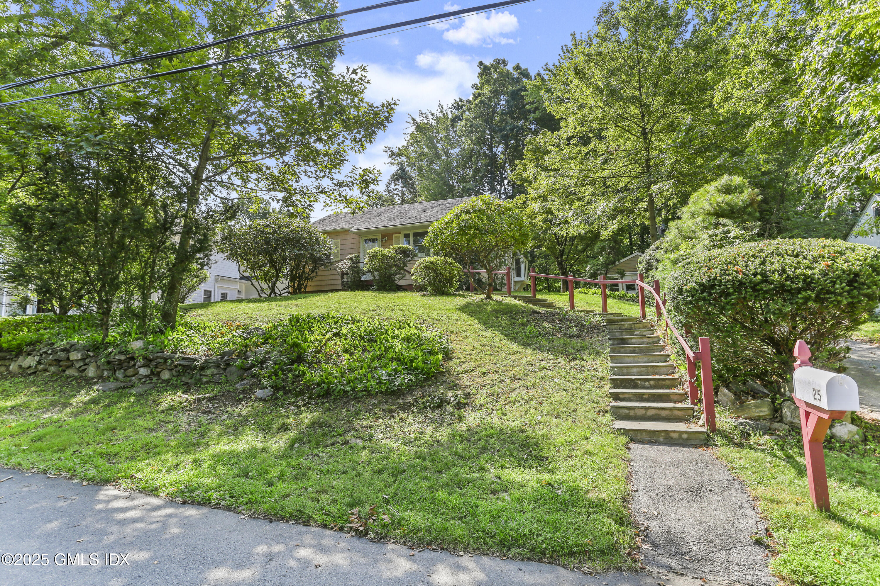 25 Circle Drive Greenwich, CT 06830 - Photo 7 of 7 a view of a garden with plants and a bench