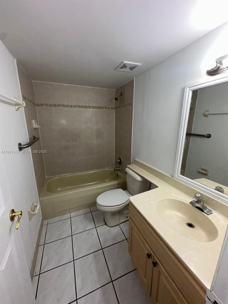 5665 West 20th Avenue, Unit 308 Hialeah, FL 33012 - Photo 11 of 17 a bathroom with a sink toilet and shower
