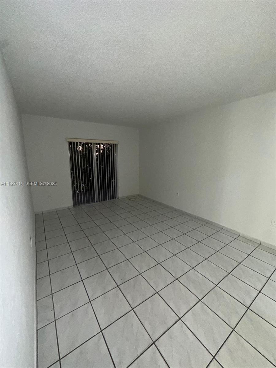 5665 West 20th Avenue, Unit 308 Hialeah, FL 33012 - Photo 12 of 17 a view of an empty room and window